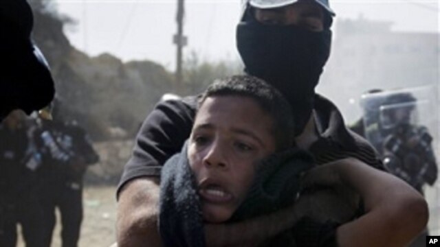 An Israeli Arab boy is detained by Israeli riot police during clashes in the northern Israeli town of Umm el-Fahm, Wednesday, Oct. 27, 2010