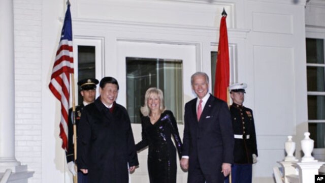 Vice President Joe Biden and Jill Biden welcome Chinese Vice President Xi Jinping to a dinner at the Naval Observatory in Washington, Tuesday, Feb. 14, 2012.