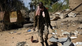 A Malian soldier walks inside a military camp used by radical Islamists and bombarded by French warplanes, in Diabaly, Mali, January 21, 2013.