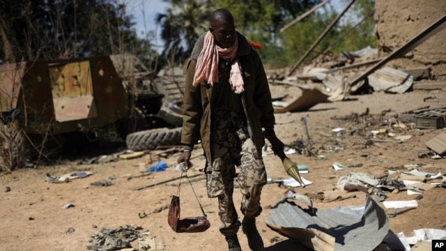 A Malian soldier walks inside a military camp used by radical Islamists and bombarded by French warplanes, in Diabaly, Mali, January 21, 2013.