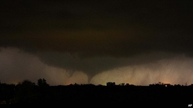 A tornado on the ground makes it way through the night near Salin, Kansas, during the third day of severe weather and multiple tornado sightings, April 14, 2012.
