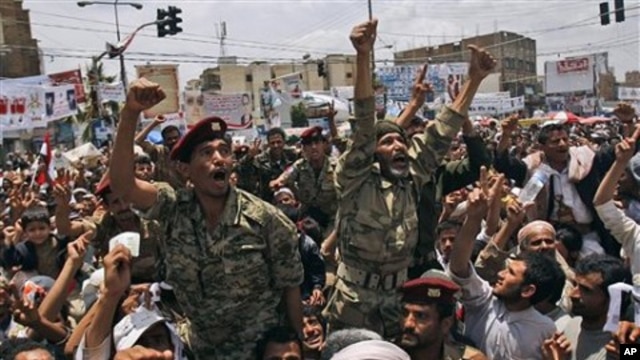 Yemeni army officers lifted by anti-government protestors gesture as they join a demonstration demanding the resignation of of Yemeni President Ali Abdullah Saleh, in Sanaa, Yemen, April 24, 2011