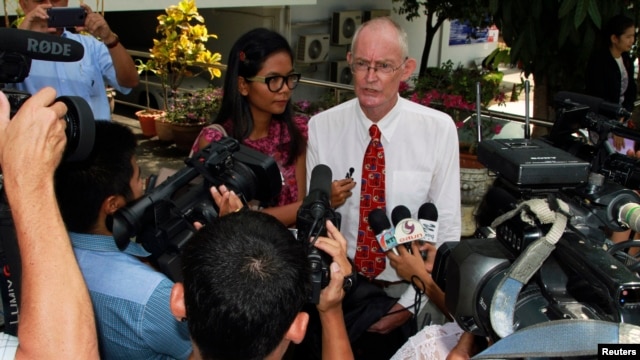 Alan Morison (R) and Chutima Sidasathian, reporters for the Phuketwan website in Phuket, April 17, 2014.