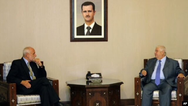 In this photo released by the Syrian official news agency SANA, Syrian Foreign Minister Walid al-Moallem, right, meets with ICRC President Jakob Kellenberger, left, in Damascus, Syria, on Sunday September 4, 2011.