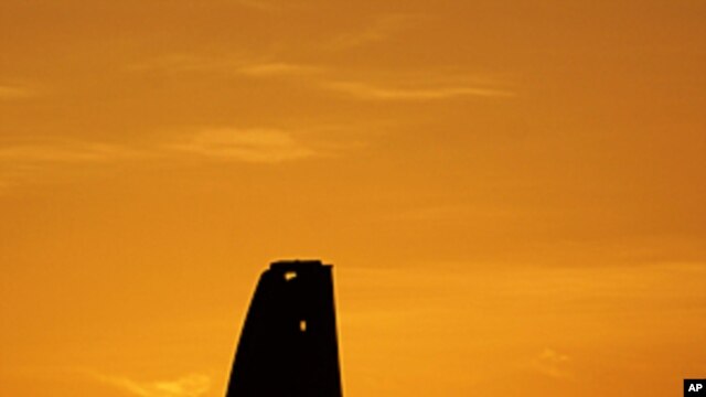 An oil pump works at sunset in the desert oil fields of Sakhir, Bahrain, in the Persian Gulf. Iran test-fired a surface-to-surface cruise missile Monday in a drill its navy chief said proved Tehran was in complete control of the strategic Strait of Hormuz
