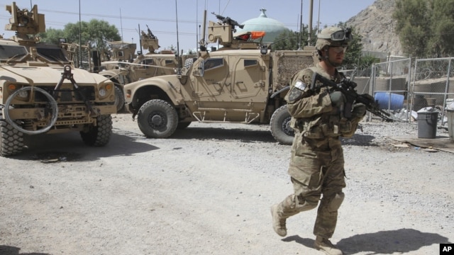 A US soldier, part of the NATO forces, patrols a police station after it was attacked by militants in Kandahar, south of Kabul, Afghanistan, June 19, 2012.