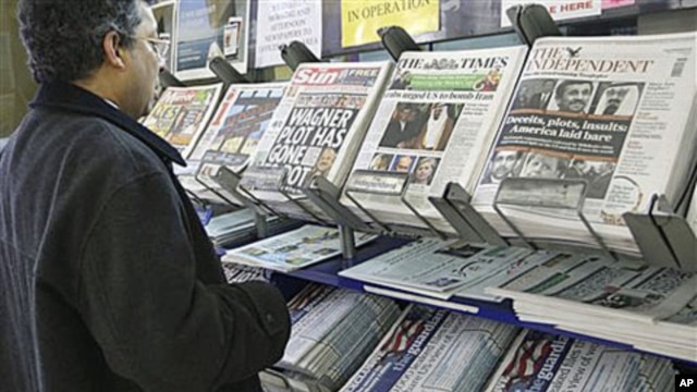 A man views a news stand displaying newspapers, some carrying the story on WikiLeaks' release of classified US State Department documents, in London.