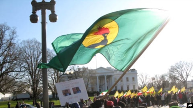 A Congolese protester waves a flag of the former Zaire in front of the White House Saturday, December 10, 2011, denouncing recent election results in the Democratic Republic of Congo.