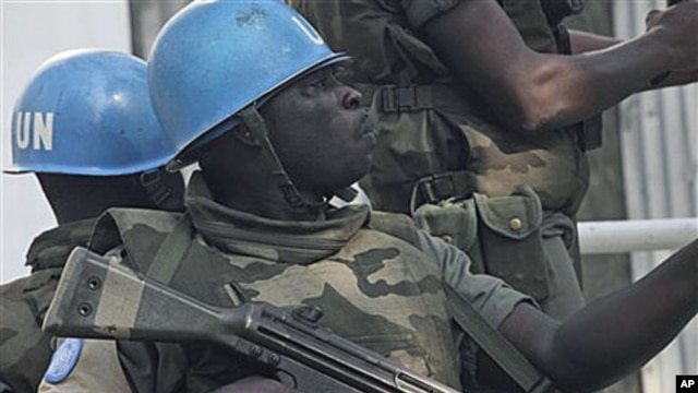 UN forces patrol on a street in Abidjan, Ivory Coast, after UN chief warns that Ivory Coast faces 'real risk' of return to civil war, Dec 22, 2010