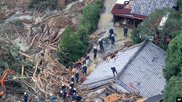 An aerial view of rescue workers searching for missing people among the debris of houses destroyed in Tanabe, Wakayama Prefecture, September 5, 2011.