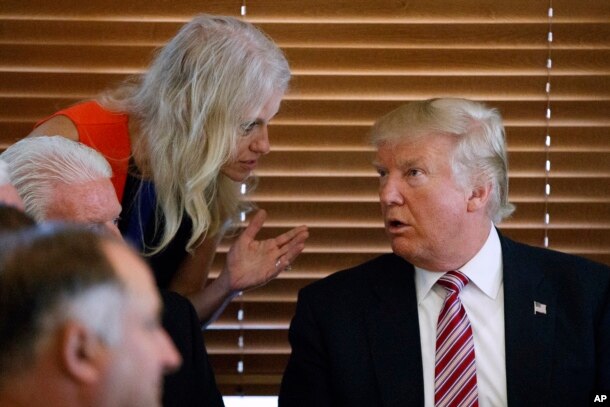 FILE - Then Republican presidential candidate Donald Trump, right, talks with his his then campaign manager, now senior adviser, Kellyanne Conway during a visit to in Brook Park, Ohio, Sept. 5, 2016.