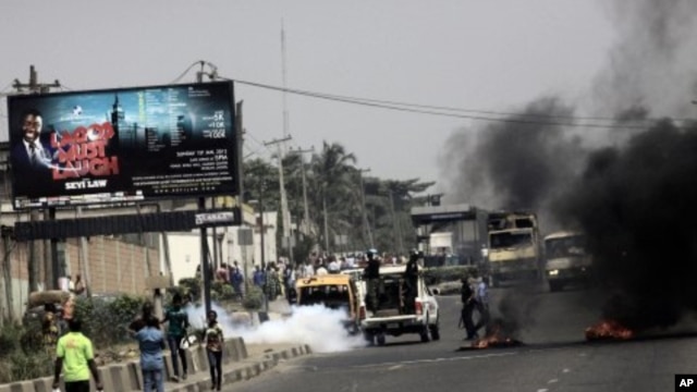 Police fire tear gas on protester on a major road in commercial capital during a fuel subsidy protest in Lagos, Nigeria, January 3, 2012.