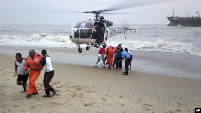 Indian Coast Guards lead crew members to safety on a rescue mission on the Indian ship Pratibha Cauvery which ran aground due to strong winds on the Bay of Bengal coast, off Chennai, India, November 1, 2012.