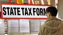 Qiao Ming picks out the necessary tax forms he will need to fill out to file the 2007 income tax returns at the Illinois Department of Revenue in Springfield, Illinois