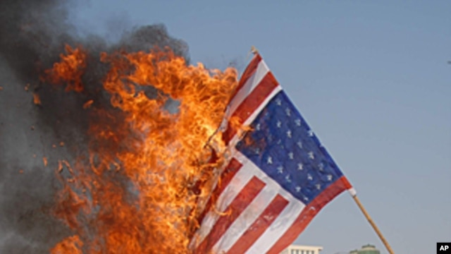 Pakistani protesters burn representation of U.S. flag at a rally to condemn drone attacks on militants allegedly hiding in Pakistan tribal areas, in Multan, Pakistan, (File January 11, 2012).