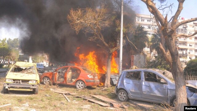 Vehicles burn after an explosion in central Damascus. (February 21, 2013)