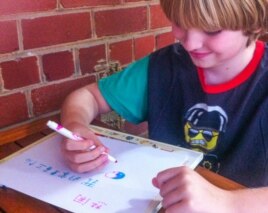 American elementary school student practicing Chinese