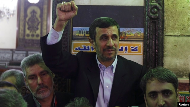 Iran's President Mahmoud Ahmadinejad (C) gestures in front of the shrine of Prophet Muhammad's grandson Hussein ibn Ali at the Al-Hussein mosque, in old Cairo, Egypt, Feb. 5, 2013.
