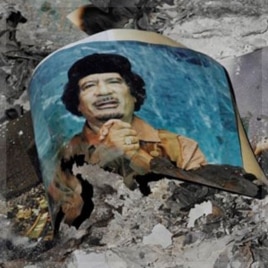 Picture of Libya's ousted leader Moammar Gadhafi is seen in the ashes in downtown Sirte, Libya, Wednesday, Oct. 12, 2011. (AP Photo/Bela Szandelszky)