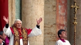 Pope Benedict the 16th waves to the crowd from the central balcony of St. Peter's Basilica after being newly elected, the Vatican, April 19, 2005.