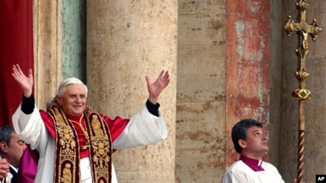 Pope Benedict the 16th waves to the crowd from the central balcony of St. Peter's Basilica after being newly elected, the Vatican, April 19, 2005.