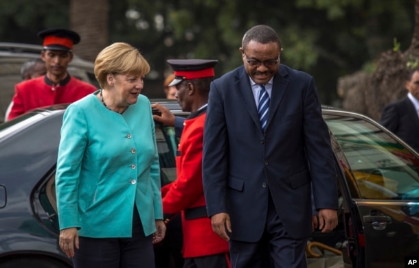 German Chancellor Angela Merkel, left, is welcomed by Ethiopia's Prime Minister Hailemariam Desalegn, as she arrives at the national palace in Addis Ababa, Ethiopia, Oct. 11, 2016.