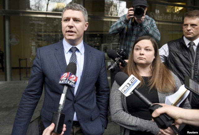 Michael Arnold, left, and Lissa Casey, attorneys representing Ammon Bundy, address the media covering the hearing of militia members outside United States District Court in Portland, Oregon, Jan. 27, 2016.