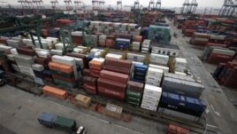 In this file photo, hundreds of shipping containers in Shanghai filled with products wait to be exported to the United States and other countries.