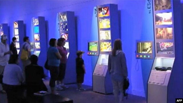 Visitors interact with the new exhibit, “The Art of Video Games,” Smithsonian’s National Museum of American Art.