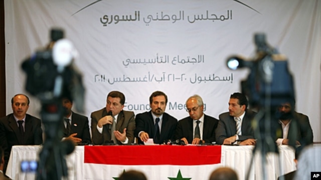 Syrian opposition members (L to R) Ahmed Ramadan, Khaled Hassaleh, Hassan Hashmi, Lovay Safi, Abdul Basit Sida, Adip Shishakil and Hassan Shalabi attend a news conference after their meeting in Istanbul, August 23, 2011