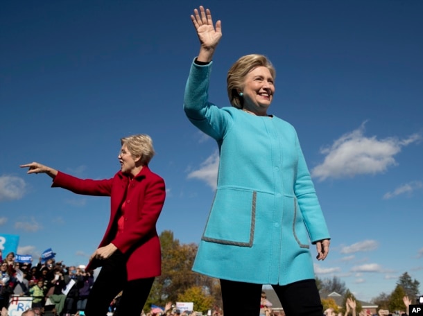 Democratic presidential candidate Hillary Clinton, right, accompanied by Sen. Elizabeth Warren, D-Mass., wave as they arrive at a rally at St. Anselm College in Manchester, N.H., Oct. 24, 2016.