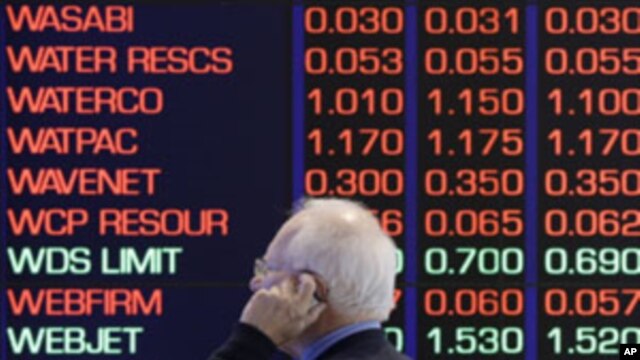 A man talks on his cellular phone at the Australian Stock market in Sydney, August 9, 2011