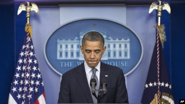 President Barack Obama pauses as he talks about the Connecticut elementary school shooting, in the White House briefing room in Washington, December 14, 2012.