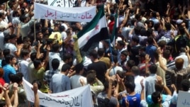A handout image released by the Syrian opposition's Shaam News Network shows anti-regime demonstrators during a protest in Homs province, May 25 , 2012. 