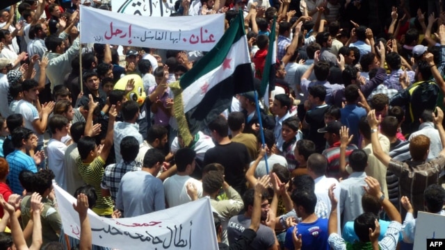 A handout image released by the Syrian opposition's Shaam News Network shows anti-regime demonstrators during a protest in Homs province, May 25 , 2012. 
