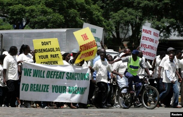 FILE - Supporters of the Zimbabwe African National Union's Patriotic Front (ZANU-PF) march in Harare to protest against a European Union decision to extend economic sanctions on Zimbabwe, Feb. 24, 2010.