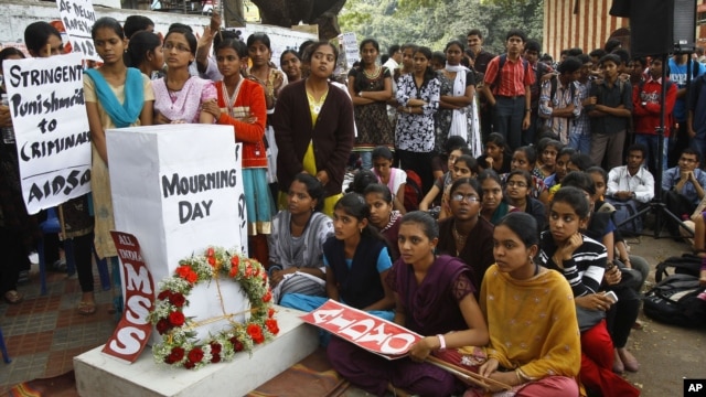 Indians gather next to a makeshift memorial to mourn the death of a 23-year-old gang rape victim, in Bangalore, India , Saturday, Dec. 29, 2012. 
