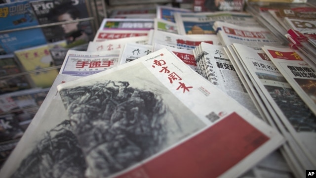 A New Year edition of Southern Weekly, center, published on January 3, 2013, is exhibited at a newsstand in Beijing, China, January 4, 2013. 