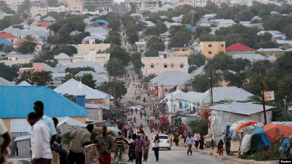 FILE - People walk along a street in Mogadishu, Somalia, Sept. 28, 2013. 