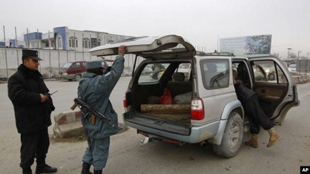 Afghan policemen search car at a checkpoint in Kabul, February 26, 2012 (file photo).