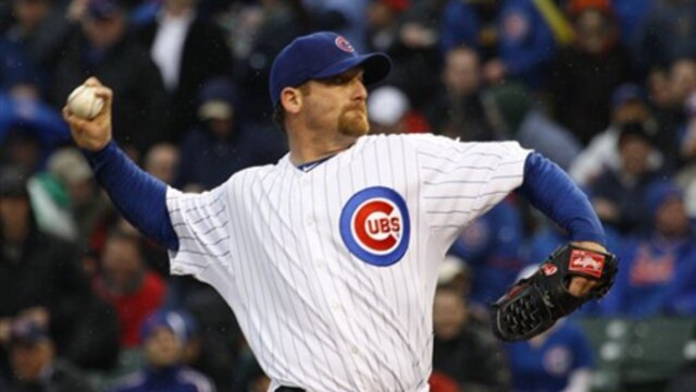 Chicago Cubs starting pitcher Ryan Dempster delivers during the first inning of an opening day baseball 