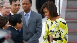 U.S. first lady Michelle Obama, right, is greeted by an unidentified Japanese official upon her arrival at Haneda International Airport in Tokyo, March 18, 2015.