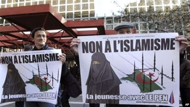 Supporters of far right-wing French politician Jean-Marie Le Pen stand in front of the courthouse in Marseille where Le Pen is accused of inciting racism in the recent anti-Muslim poster campaign by the youth wing of his party, the Front National, 05 Mar 