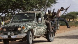 Fighters from the moderate Ahlu Sunna forces arrive at a road checkpoint outside Mareergur town, 30 km (19 miles) to the north of Dhusamareeb, in central Somalia Dec. 17, 2012. (Reuters)