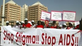 People holding banners march to campaign for increased aids awareness in the streets of Nigeria's capital Abuja December 1, 2006 on World Aids Day.