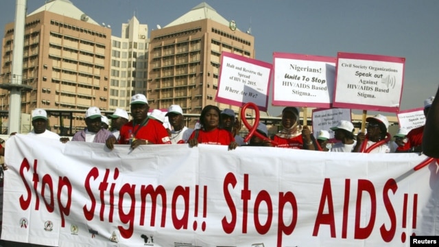 People holding banners march to campaign for increased aids awareness in the streets of Nigeria's capital Abuja December 1, 2006 on World Aids Day.