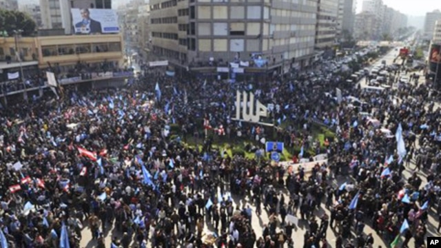 Demonstrators carry flags during a ‘day of rage’ to protest at a major square in the northern port city of Tripoli, Lebanon, January 25, 2011