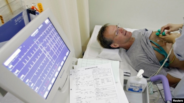 FILE - A stroke patient undergoes an electrocardiogram while recovering at Juntendo University Hospital in Tokyo. 