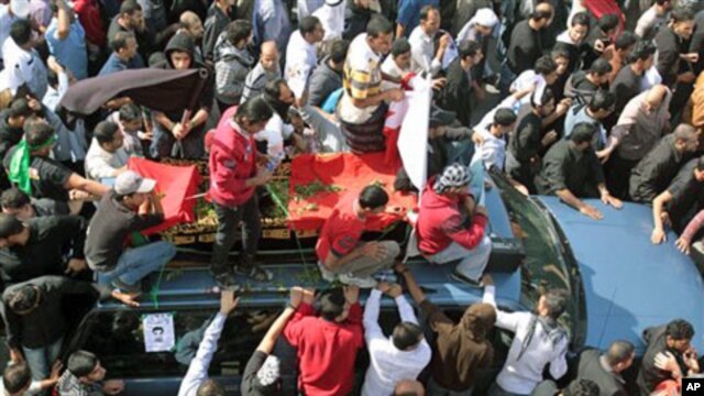 A funeral procession for Ali Abdulhadi Mushaima, 21, who was killed in clashes Monday in nationwide anti-government protests, moves slowly through the streets of Jidhafs, Bahrain, February 15, 2011