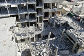View of buildings damaged by what activists said were missiles fired by a Syrian Air Force fighter jet loyal to President Bashar al-Assad at Jessreen area in Ghouta, east of Damascus, December 2, 2012.